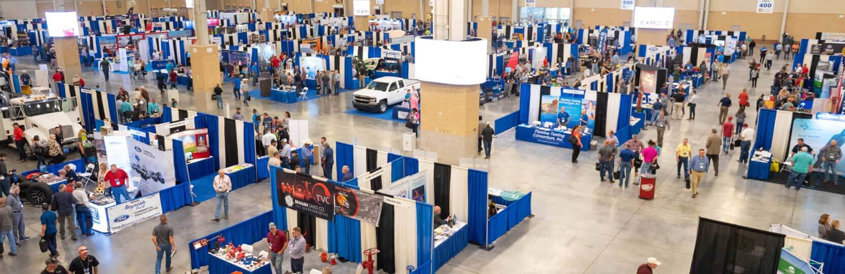 Overview of Expo exhibition space, showing booths and attendees