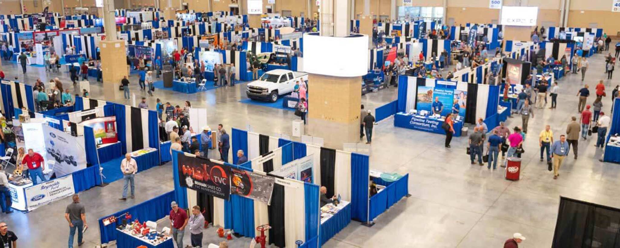 Overview of Expo exhibition space, showing booths and attendees