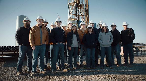 Employees in front of a drilling machine