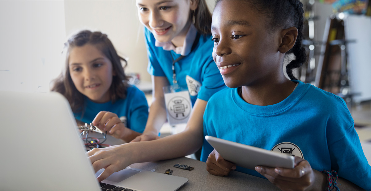 Kids working together on laptop computer and tablet