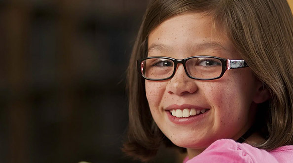 Girl with glasses smiling