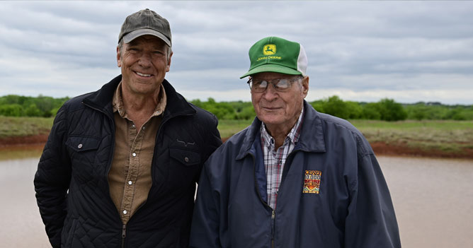 Mike Rowe with a farmer