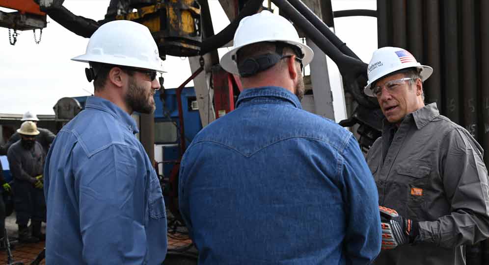 Mike Rowe with technicians in the field