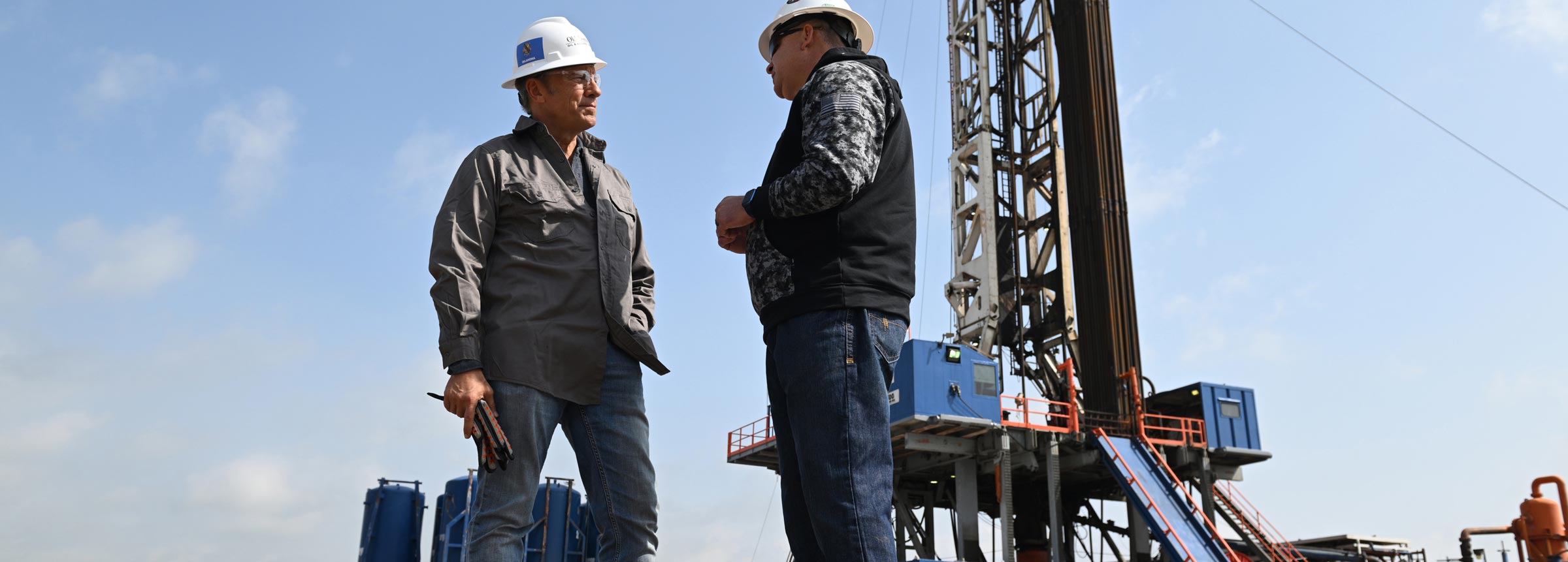 Mike Rowe and technician by a drilling platform