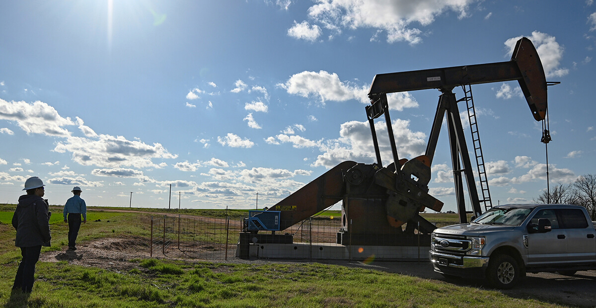 People looking at an oil well