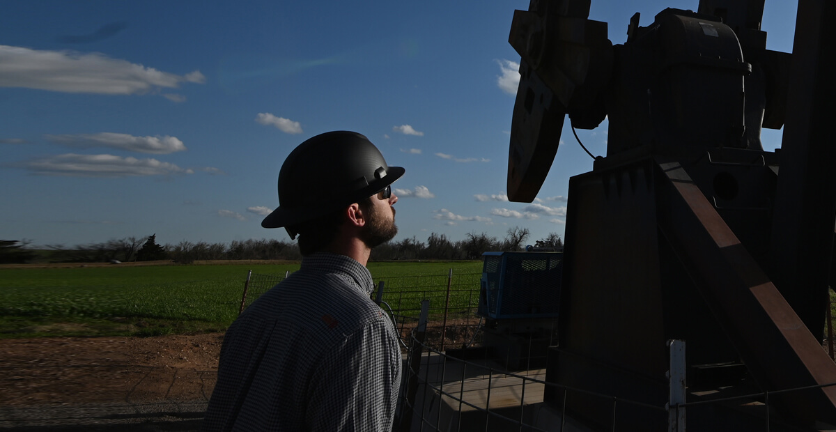 Technician inspecting an oil well