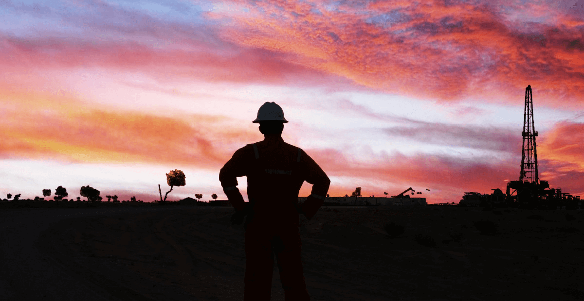 Sunset and silhouette of oil rig and oil worker