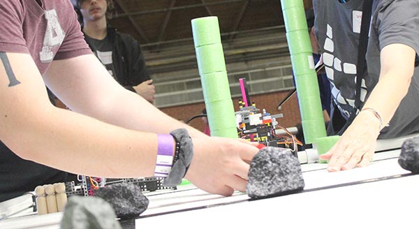 Participants work with items in a Botball experiment