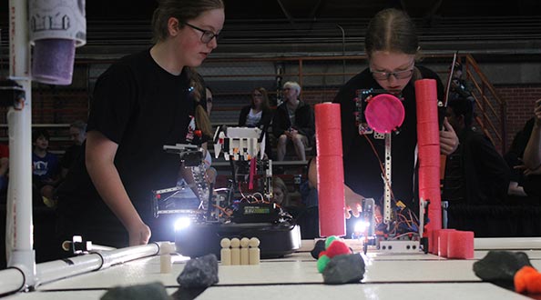 Two students experimenting with robotics