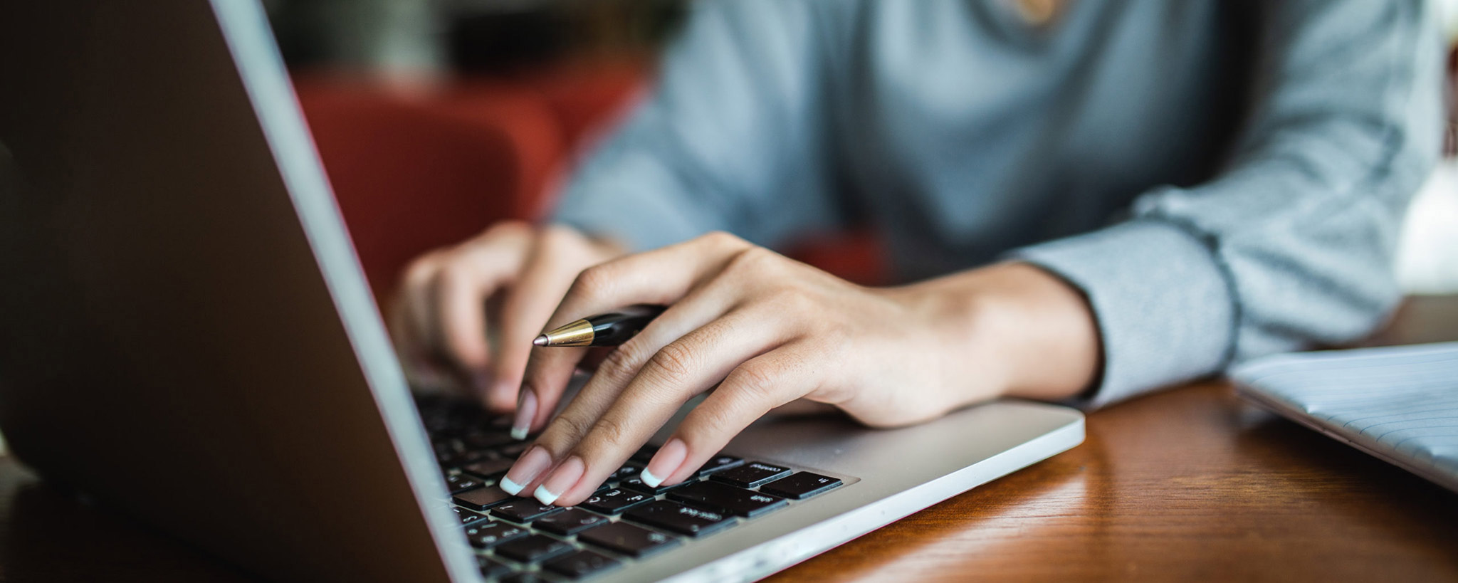 College student typing on a laptop computer