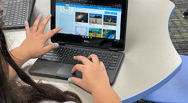 Child working on small laptop computer