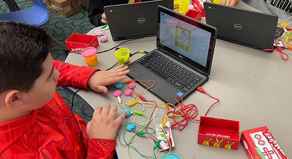 Child experimenting with an app with wiring inputs