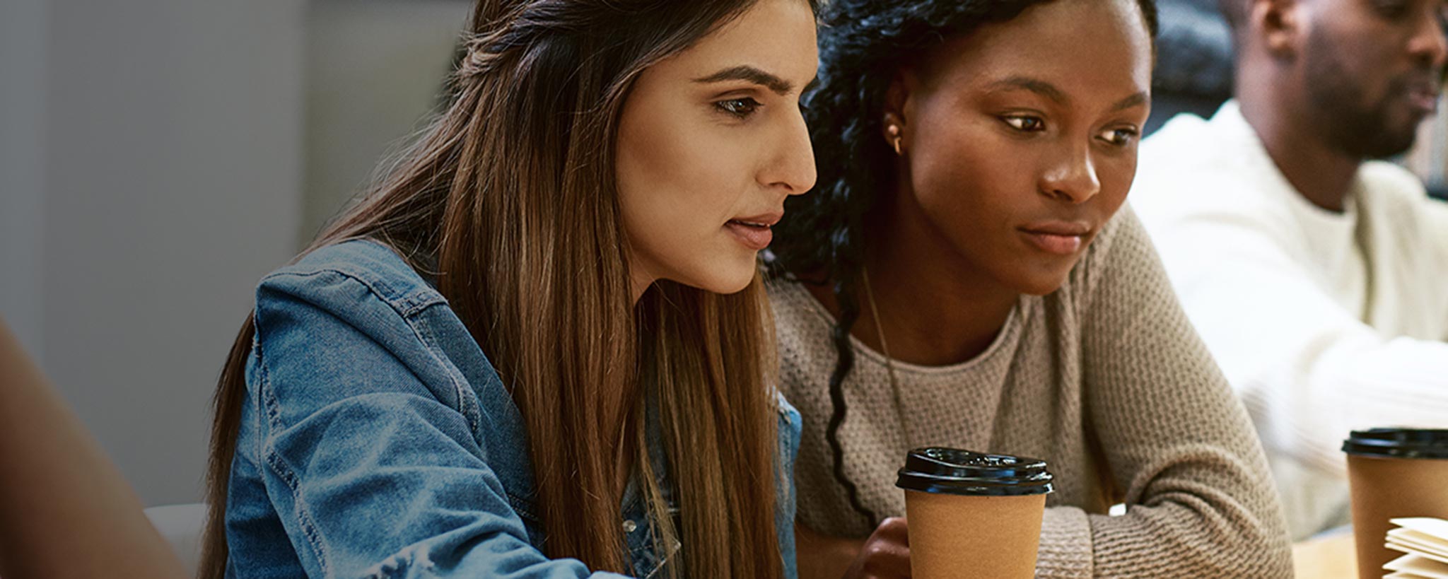 Female students reviewing data for class