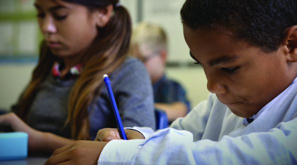 Boy writing in a notebook