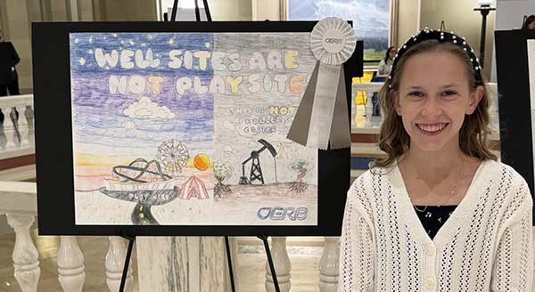 Well site safety winner with artwork depicting an oil well juxtaposed with a carnival