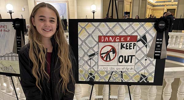 Well site safety winner with artwork depicting a "Danger, Keep Out" caution sign