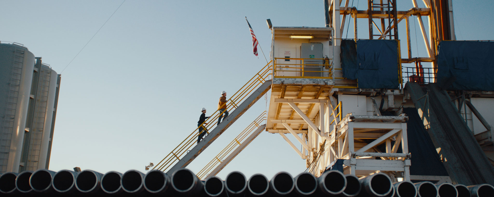 workers climbing stairs of a drilling platform