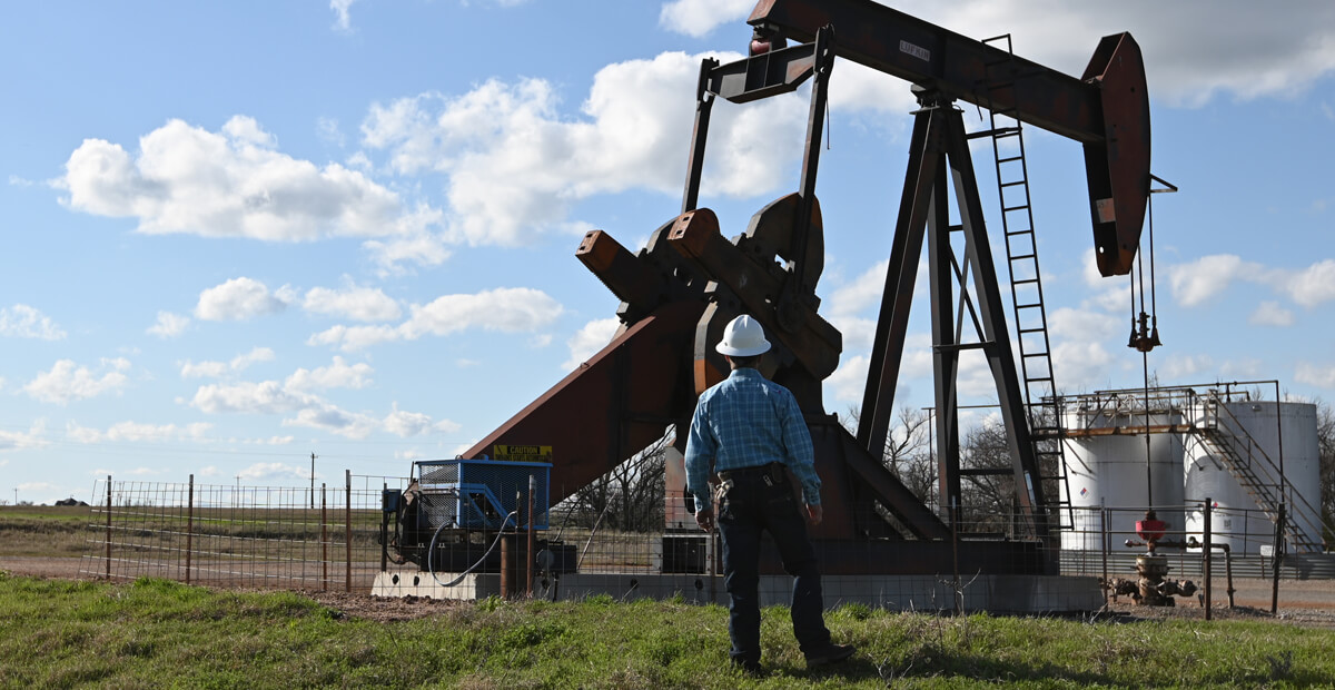 Oil pump with technician in foreground