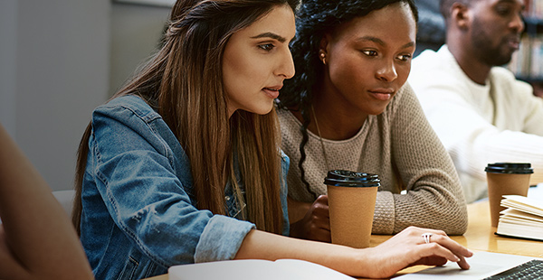 Female students reviewing data for class