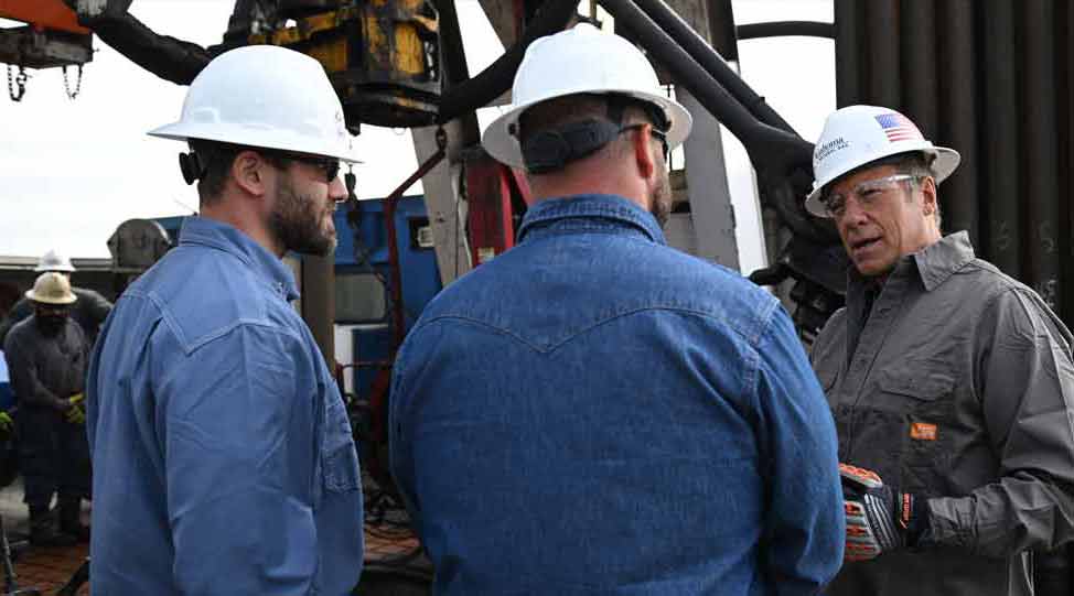Mike Rowe with technicians in the field