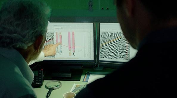 Technicians examine graphs on computer screens