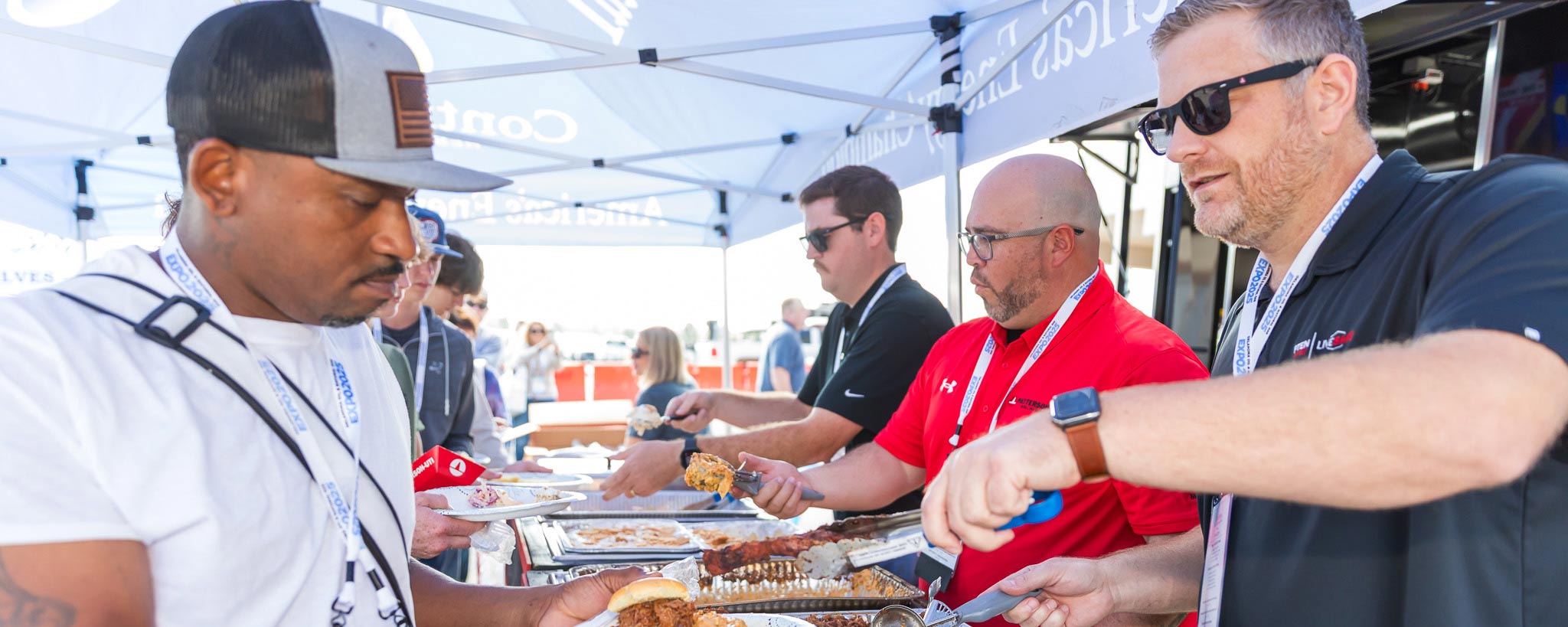 Man serving bbq to attendee