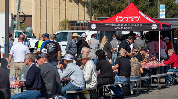 BBQ event attendees dining at tables outside